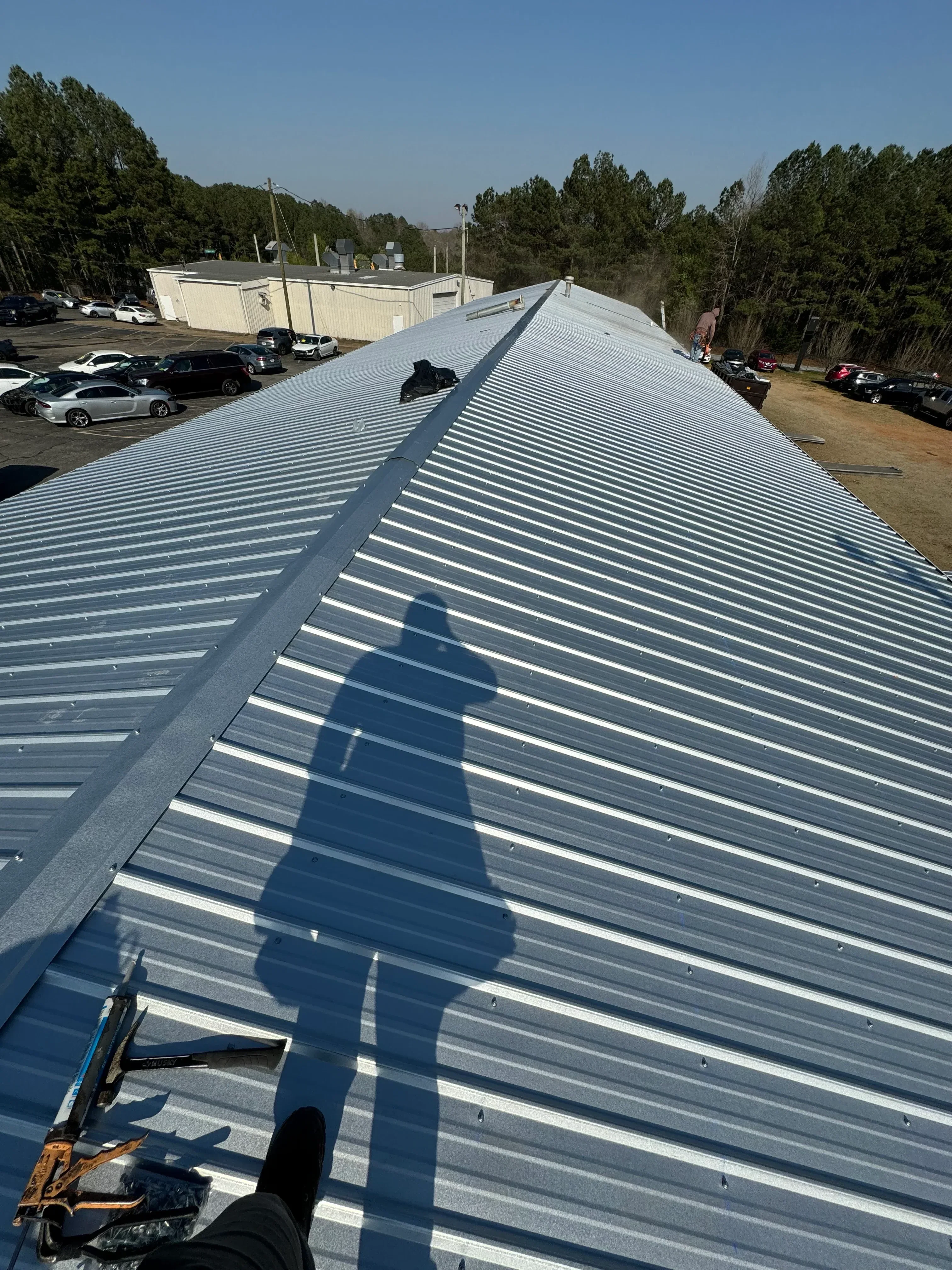 Corrugated metal roof panels installed on residential structure with standing seam detail