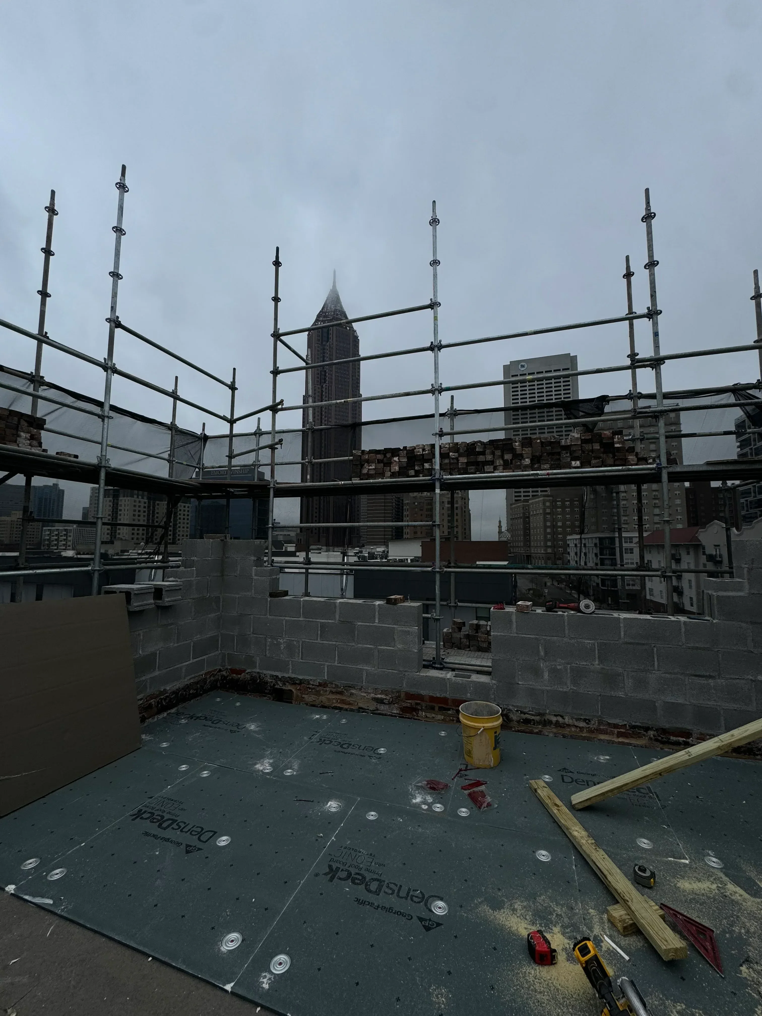 Commercial roof installation with metal framing, membrane material, and anchor point systems