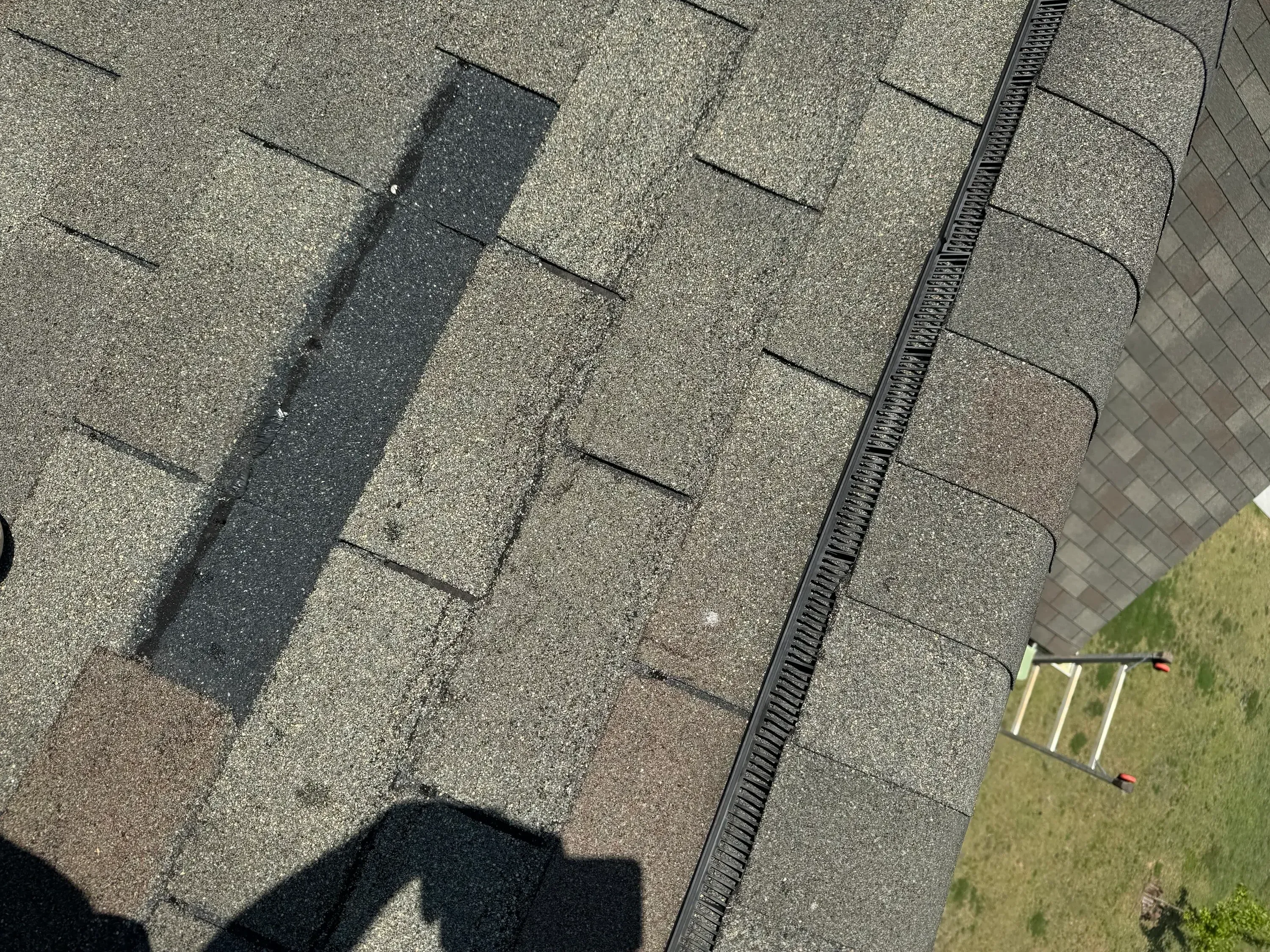 Asphalt shingles with black ridge vent and underlayment installed on pitched roof